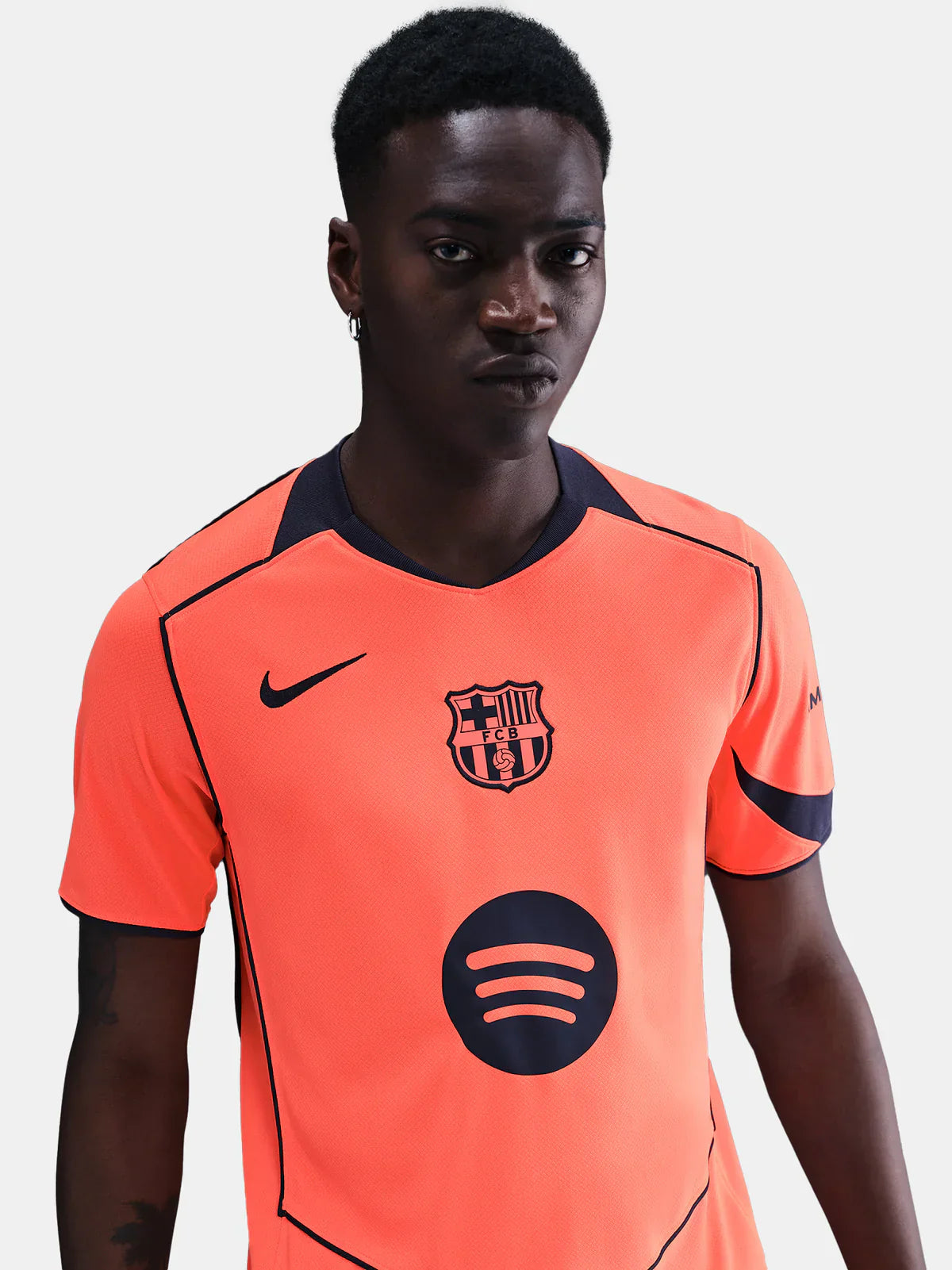 FC Barcelona 25/26 third jersey in bright orange with navy accents