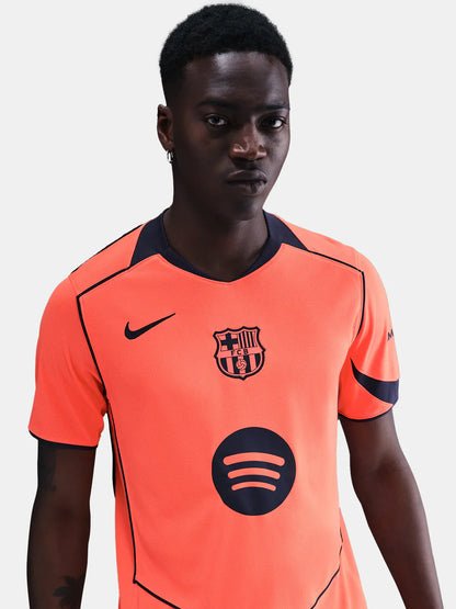 FC Barcelona 25/26 third jersey in bright orange with navy accents